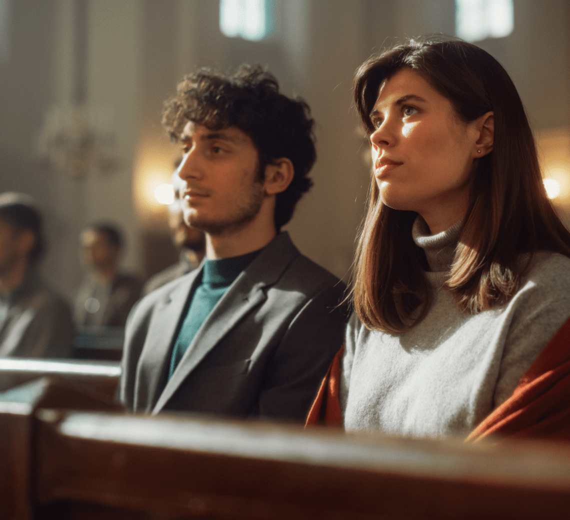 A man and woman in church looking up at the sky.