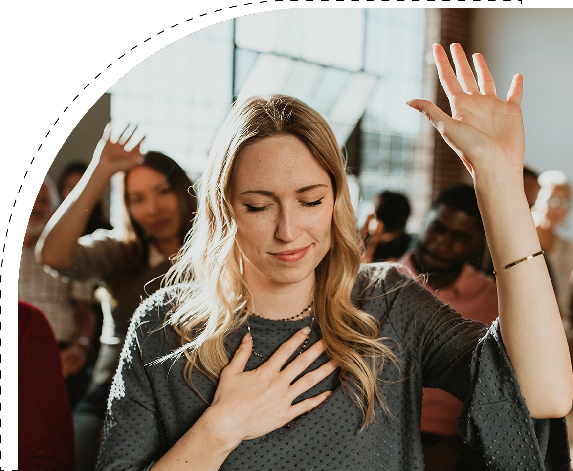 A woman with her hands up in the air.