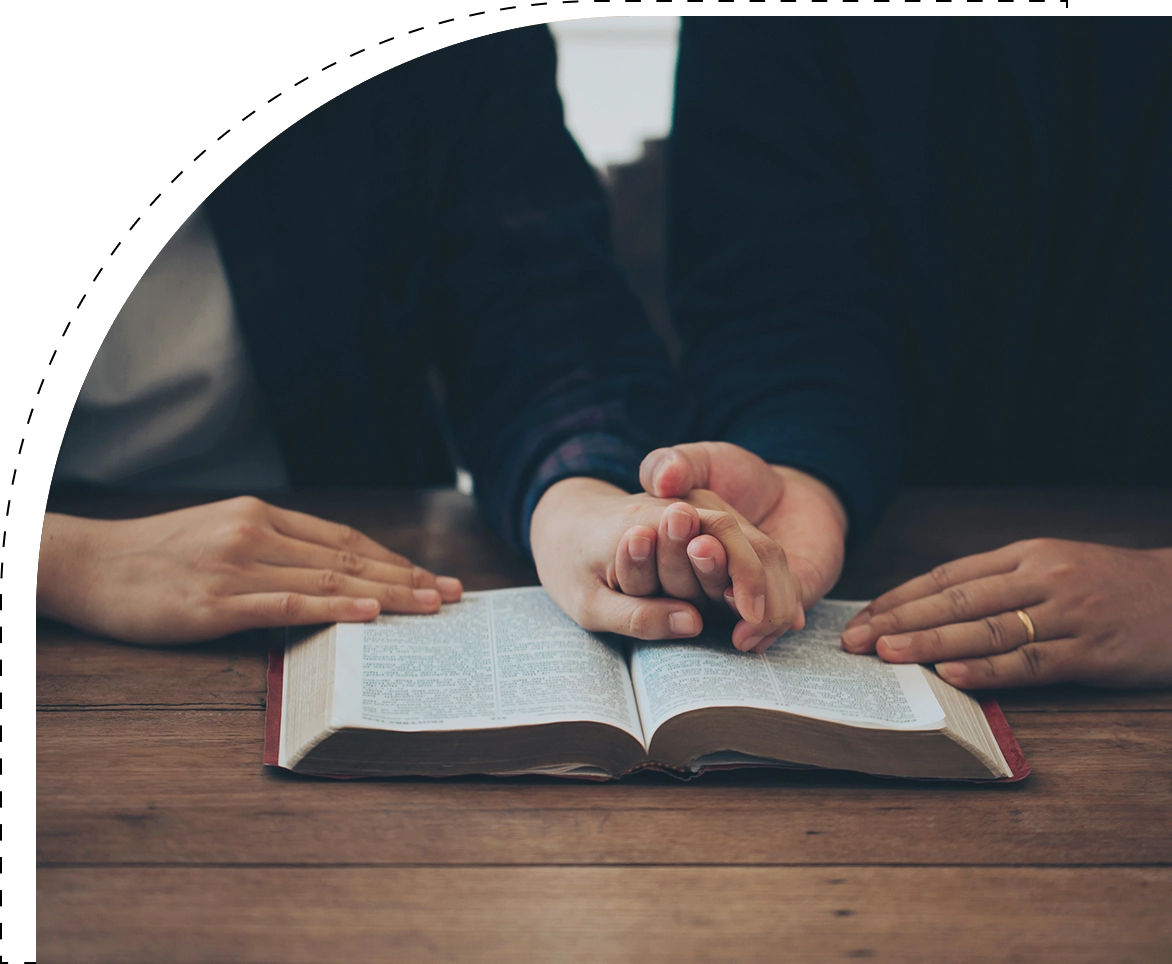 A person is reading an open book on the table