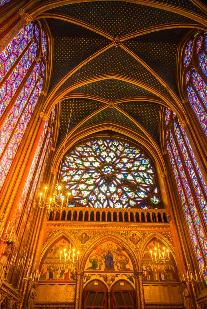 A cathedral with stained glass windows and arches.