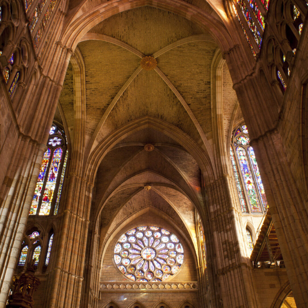 A cathedral with stained glass windows and arches.