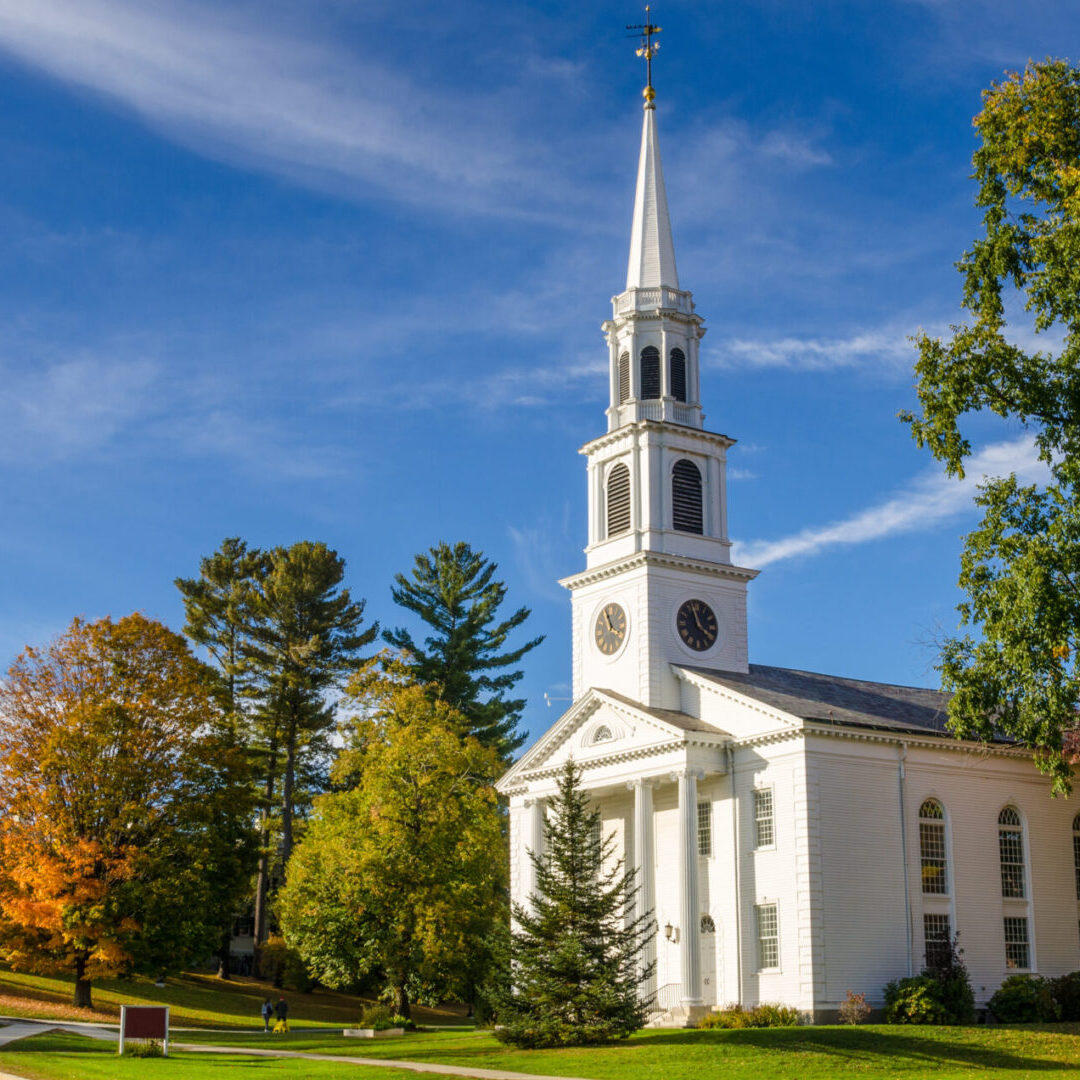 A church with trees and blue sky in the background